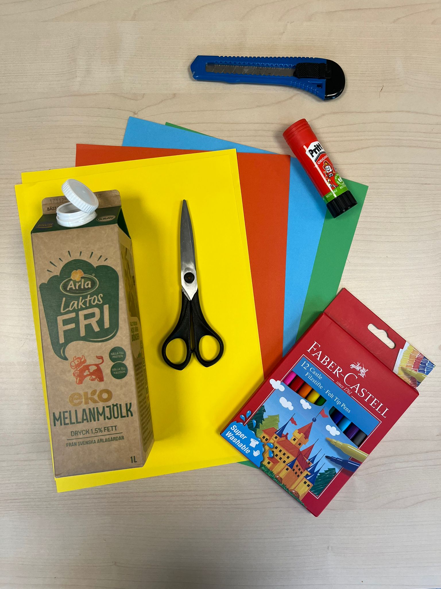 Använd färgad papper som du river sönder i små bitar och klistrar på kartongen.